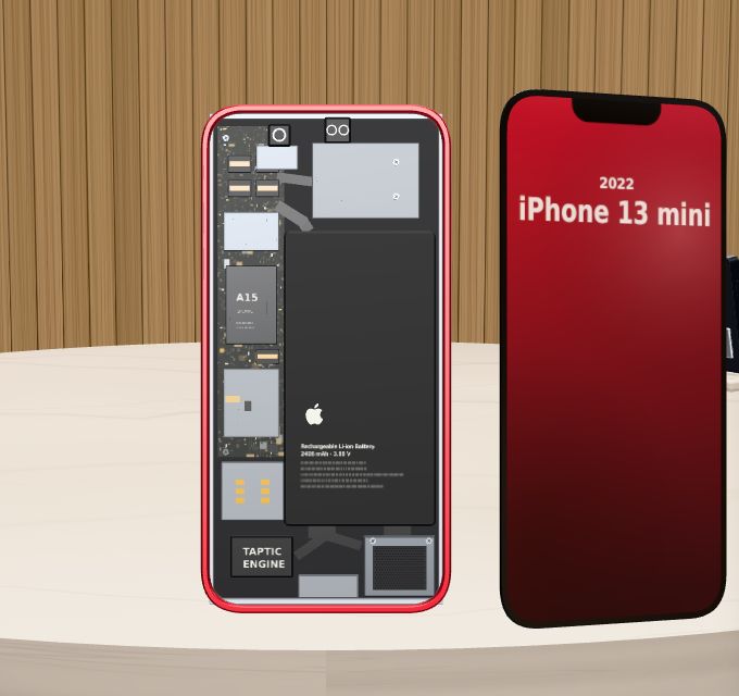 The iPhone 13 mini opened from the front: logic board with the A15 on the left, battery on the right, Taptic Engine at the bottom.
