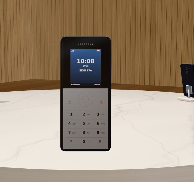 The Motorola SLVR L7e held up, showing its small screen and flat metal keypad.