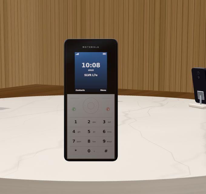 Day 1's SLVR: a silver keypad phone held up.